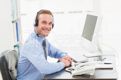 Smiling businessman speaking with headset