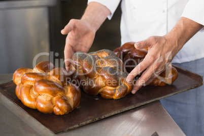 Baker checking freshly baked bread