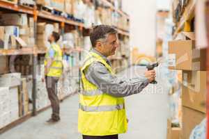 Warehouse worker scanning barcode on box