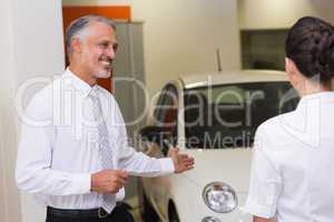 Businessman showing a car to a woman