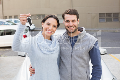 Young couple smiling holding new key