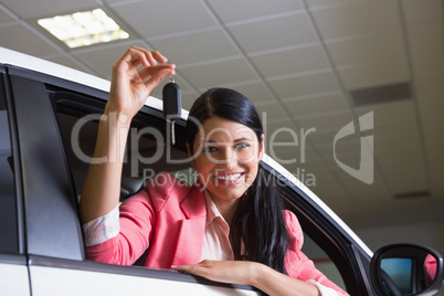 Smiling woman holding car key