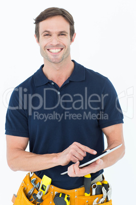 Happy handyman using digital table