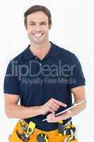 Happy handyman using digital table