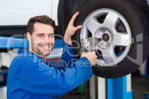 Mechanic adjusting the tire wheel