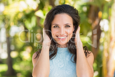 Stylish brunette smiling in the park
