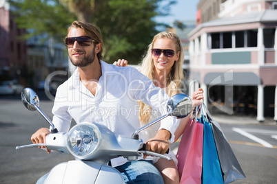 Attractive couple riding a scooter