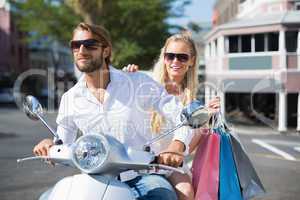 Attractive couple riding a scooter