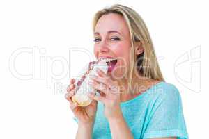 Smiling blonde eating sandwich and looking at camera