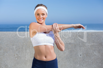 Fit blonde stretching on the pier