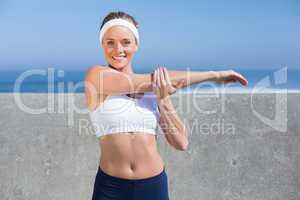 Fit blonde stretching on the pier