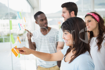 Teamwork pointing and reading sticky notes