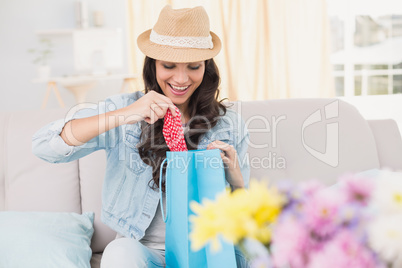 Pretty brunette opening shopping bag