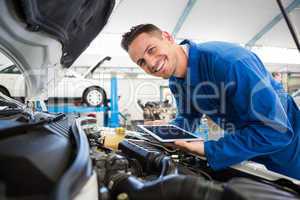 Mechanic using tablet on car