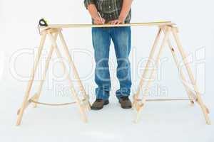 Construction worker marking wooden table