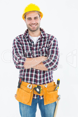 Confident male handyman wearing tool belt