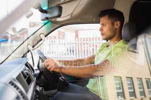 Serious delivery man driving his van