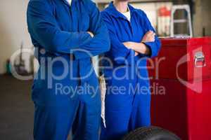 Team of mechanics standing with arms crossed