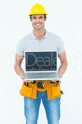 Happy carpenter holding laptop