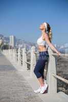 Fit blonde standing on the pier