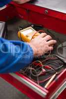 Mechanic taking a diagnostic tool from drawers