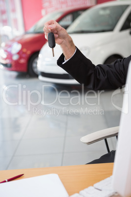 Close up of businessman holding car key Close up of businessman holding car key