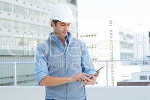 Male architect using digital tablet