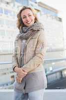 Happy blonde in warm clothes posing