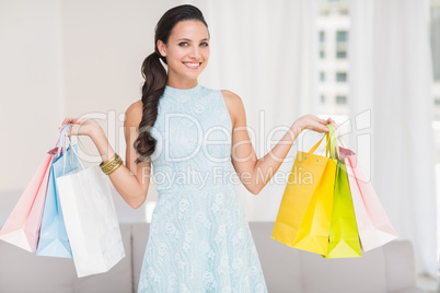 Stylish brunette with shopping bags