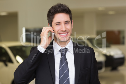 Smiling businessman calling with his mobile phone