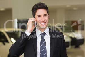 Smiling businessman calling with his mobile phone