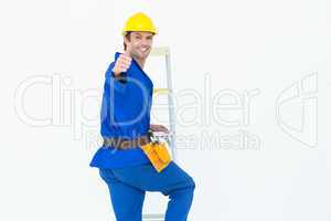 Repairman gesturing thumbs up while climbing step ladder