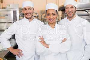 Team of bakers smiling at camera