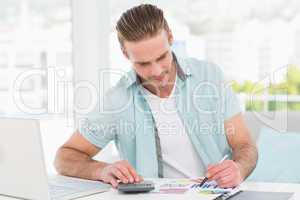 Casual businessman working with calculator