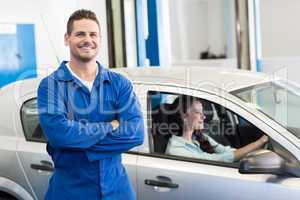 Mechanic smiling at the camera