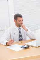 Businessman looking his laptop at his desk