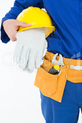 Cropped image of repairman holding helmet and gloves