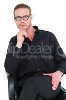 Businessman sitting on an office chair with hand on chin