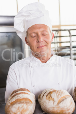 Baker smelling freshly baked breads