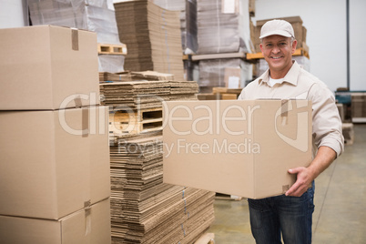 Portrait of worker carrying box