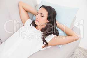 Pretty brunette napping on couch