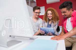Cheerful student working on tablet pc together