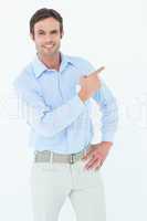 Confident businessman pointing at copy space
