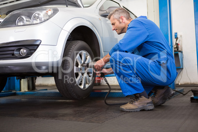 Mechanic adjusting the tire wheel