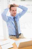 Stressed businessman sitting at his desk