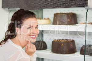 Pretty brunette looking at cake