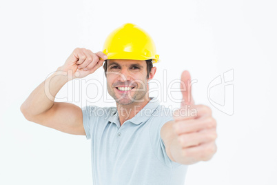 Architect wearing hardhat while showing thumbs up sign