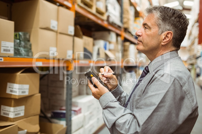 Focused male manager using handheld