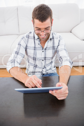 A smiling man using a tablet