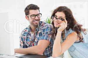 Happy coworkers with glasses posing